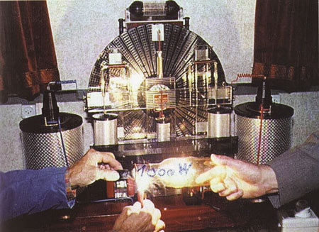 Still, with handwriting, from an 8mm film of the Testatika, which is shown powering a 1000-watt bulb.
